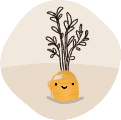 Eine Karotte mit lächelndem Gesicht die im Boden steckt